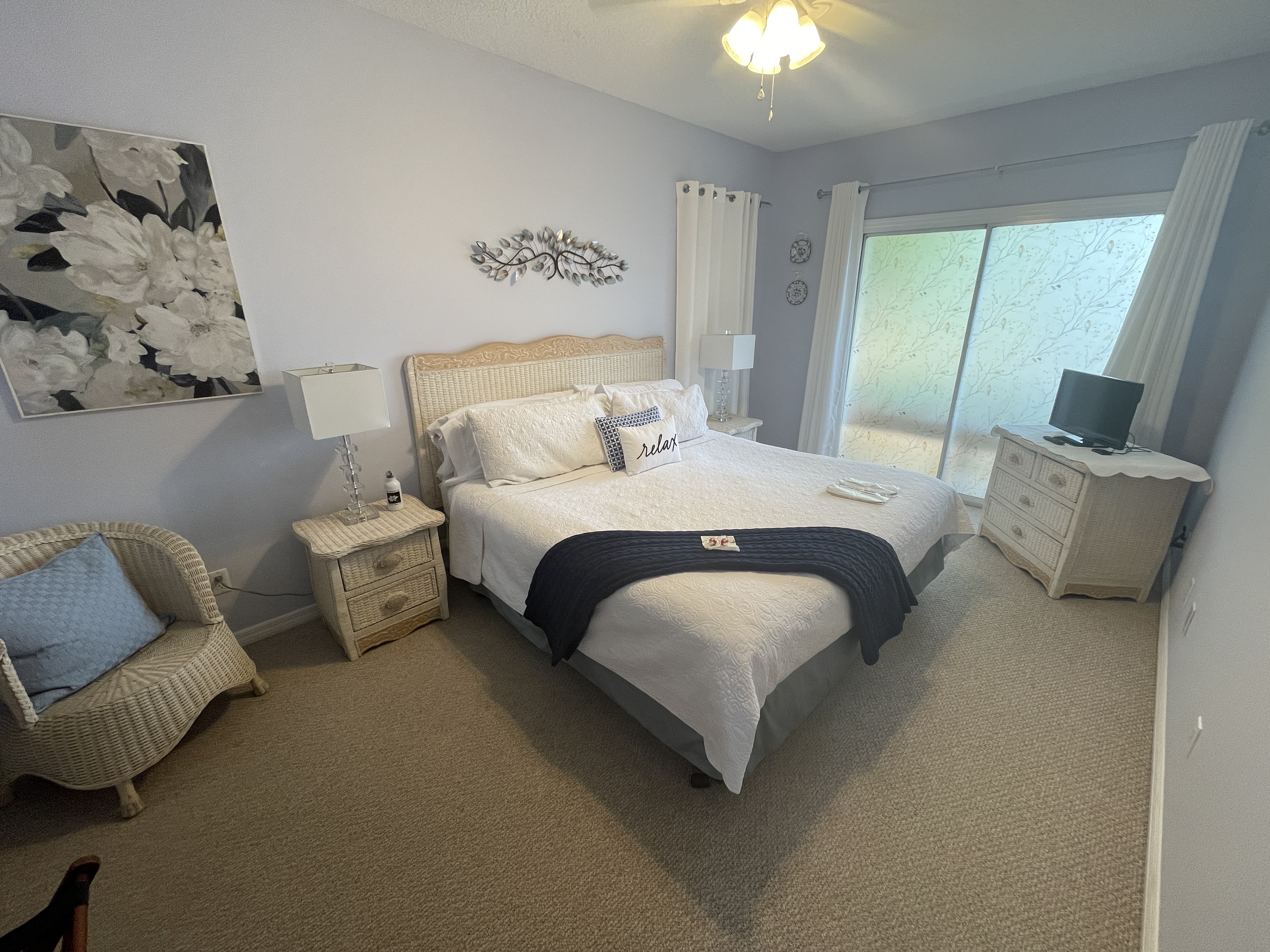 Bright, modern bedroom featuring a comfortable king bed and stylish white and blue decor.