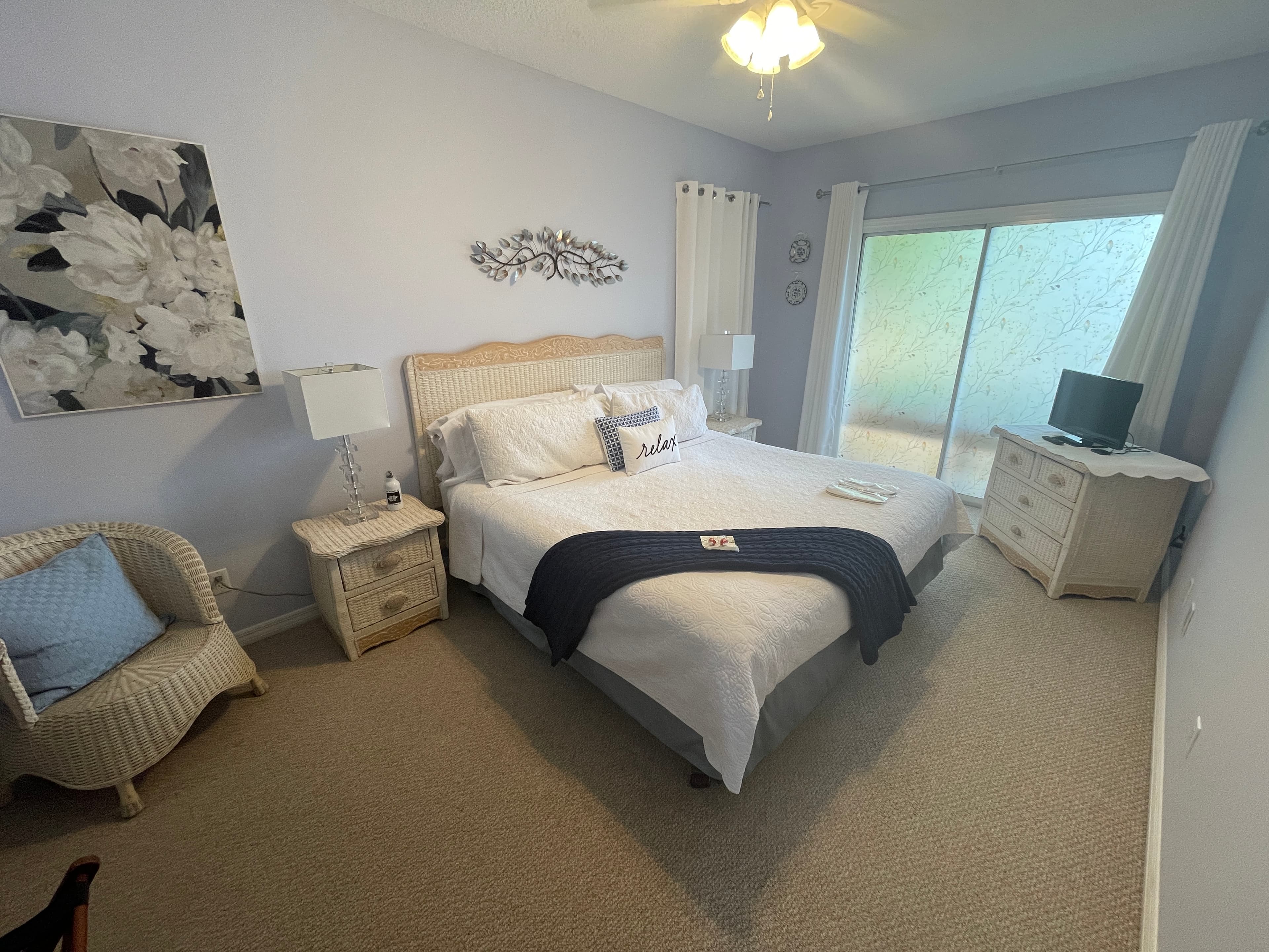 Bright, modern bedroom featuring a comfortable king bed and stylish white and blue decor.